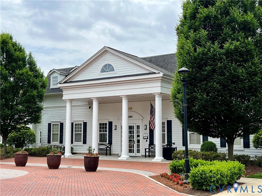 1901 Liesfeld Parkway, West Broad Village, Glen Allen, VA 23060 Columned entry with pediment and arched window, brick paver driveway, dormer window, and mature landscaping