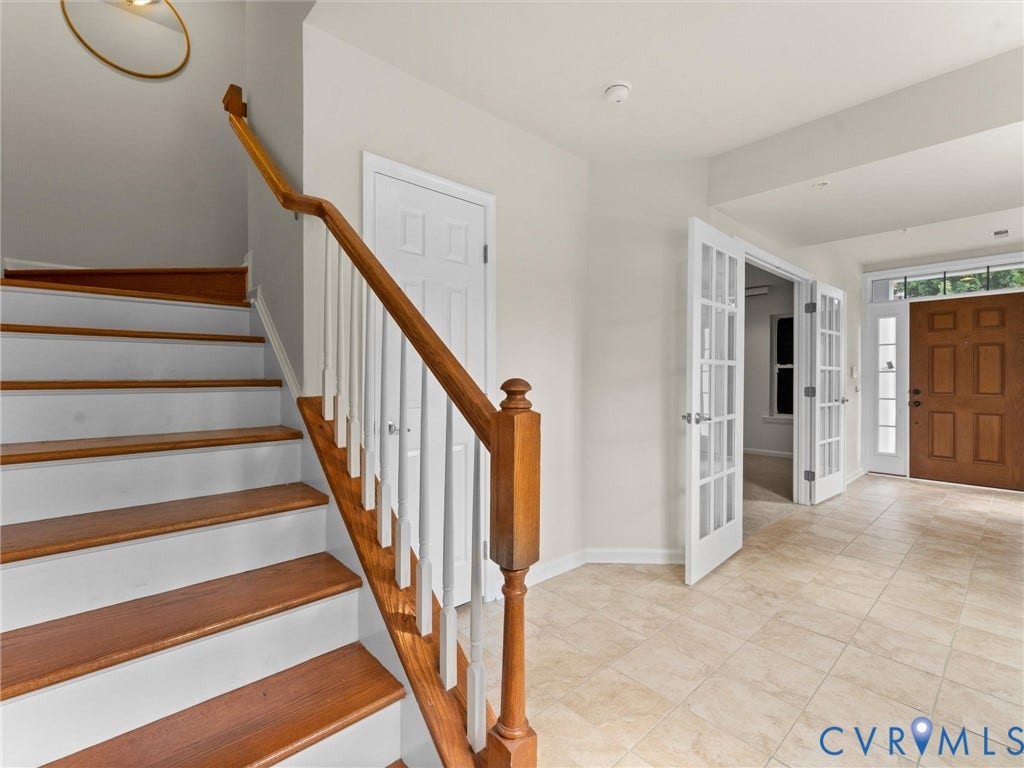 1901 Liesfeld Parkway, West Broad Village, Glen Allen, VA 23060 Hardwood staircase with white risers, tiled flooring, French doors, and a wood-paneled entry door with transom window