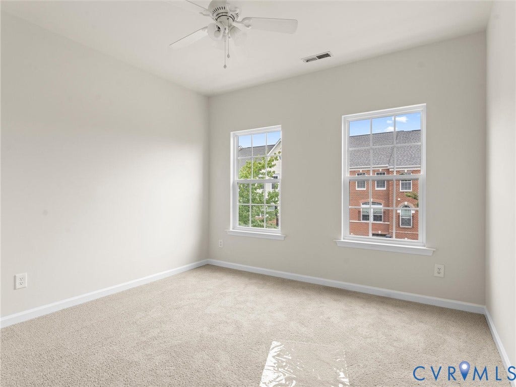 1901 Liesfeld Parkway, West Broad Village, Glen Allen, VA 23060 Neutral wall paint, beige carpeting, two large windows, and a ceiling fan