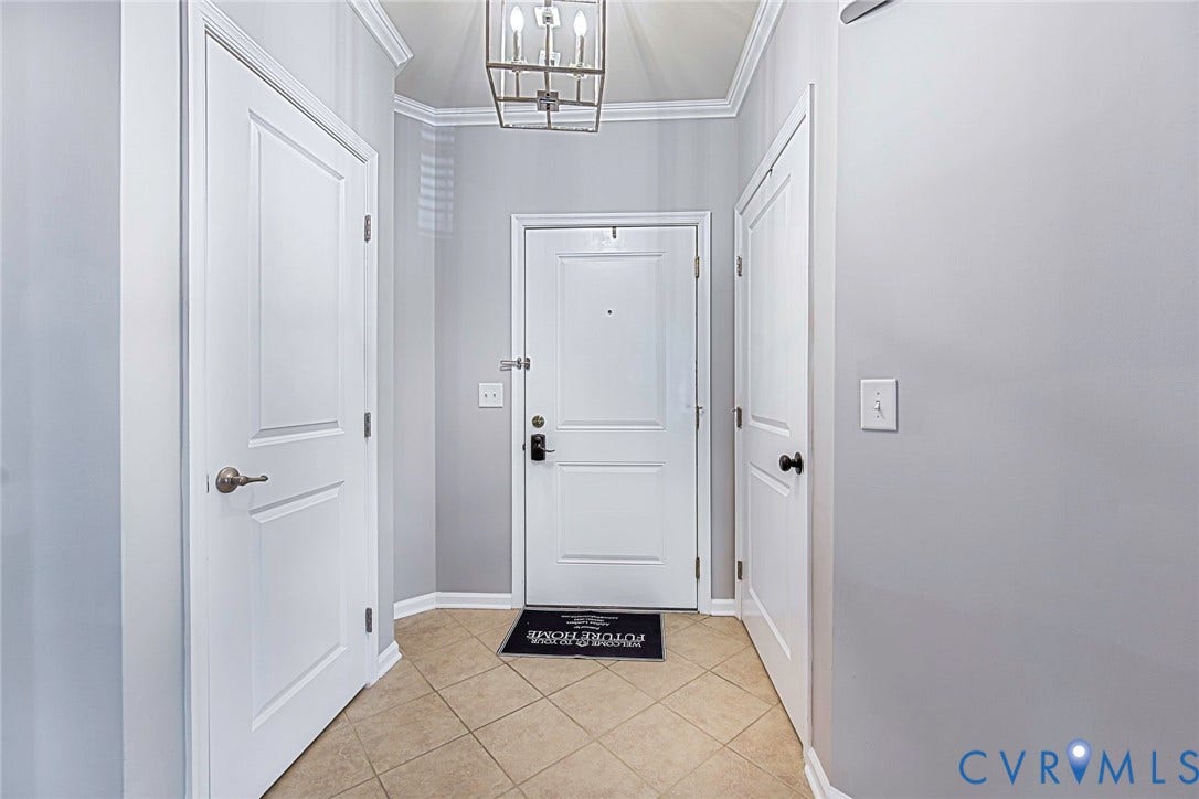Welcoming foyer with tile floor, fresh paint and 2 large storage closets