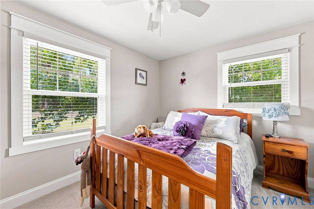 1108 Schroeder Road, Powhatan, VA 23139 Carpeted flooring, two large windows with blinds, a ceiling fan, and white trim