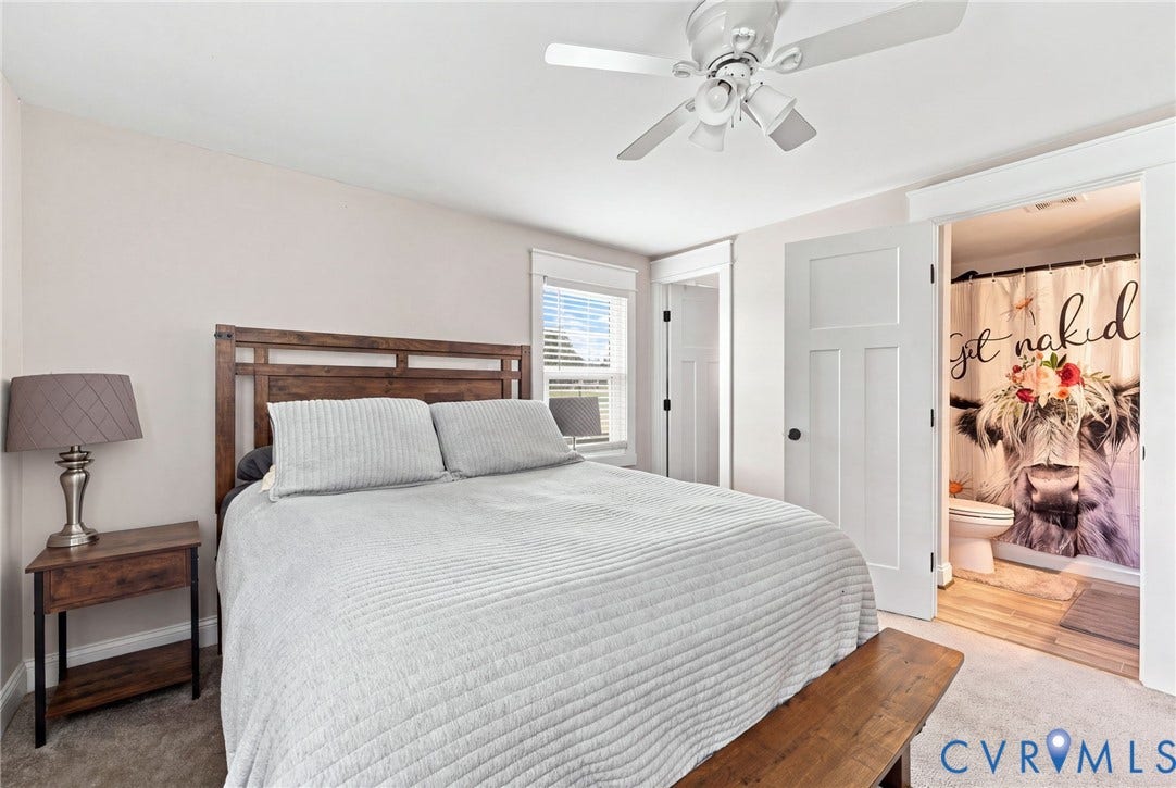 1108 Schroeder Road, Powhatan, VA 23139 White ceiling fan with light kit, warm gray wall paint, white trim work, wood-finish headboard, and solid core interior doors