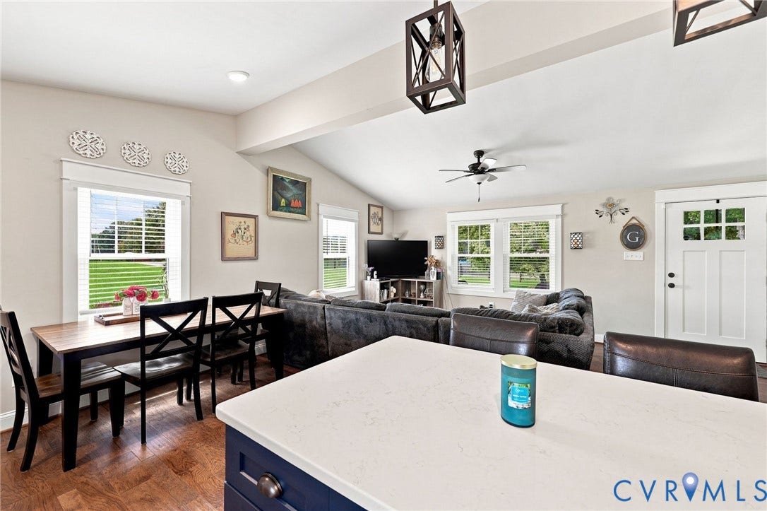 1108 Schroeder Road, Powhatan, VA 23139 Vaulted ceilings with exposed beams, wood-finish flooring, white trim window frames, and a white paneled entry door