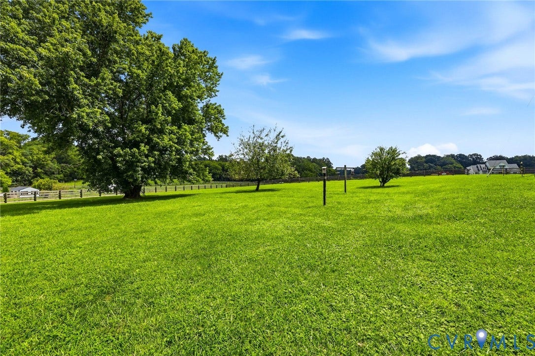 1108 Schroeder Road, Powhatan, VA 23139 Expansive verdant lawn with mature trees and a perimeter fence