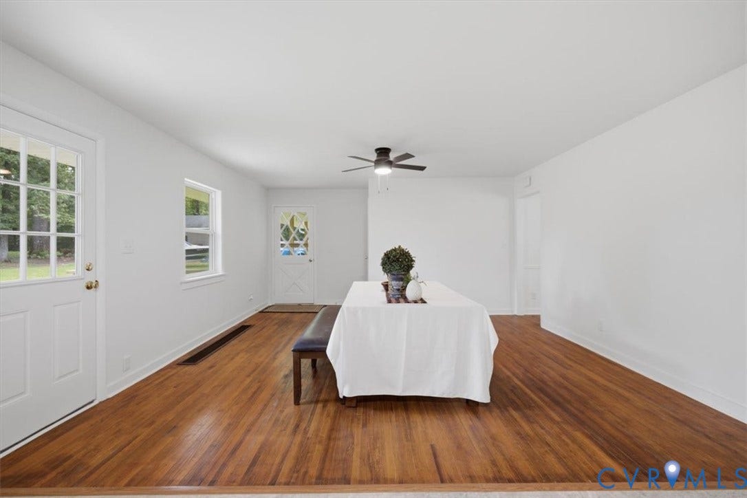 2338 Georges Road, Powhatan, VA 23139 Hardwood flooring, white painted walls, white trim, ceiling fan, and multiple windows with natural light