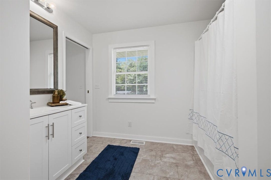 2338 Georges Road, Powhatan, VA 23139 White vanity with a rectangular sink, wall-mounted mirror, and tile flooring