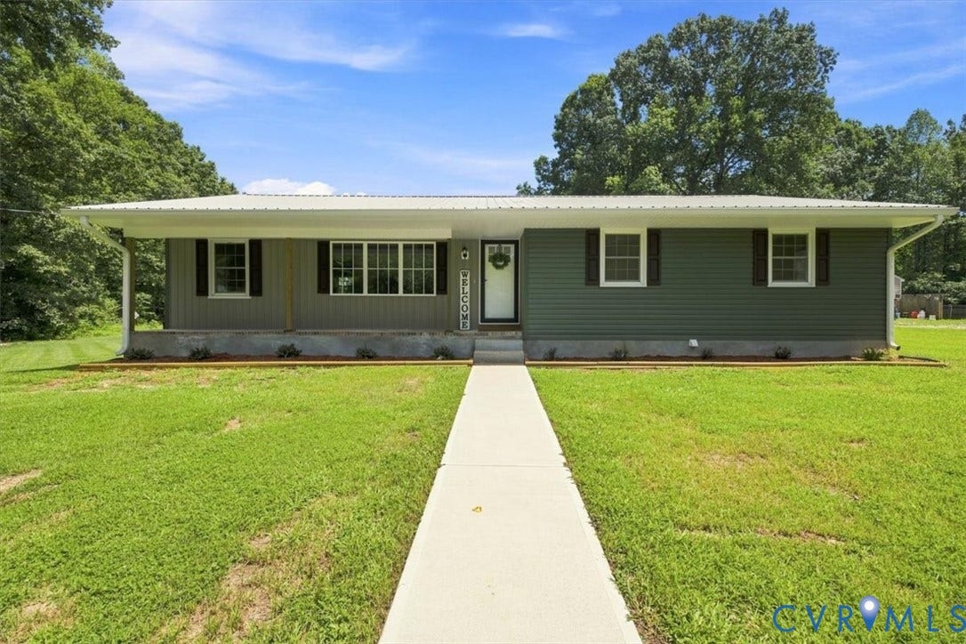 2338 Georges Road, Powhatan, VA 23139 Siding exterior with multiple window styles, covered front porch, concrete walkway, and a metal roof
