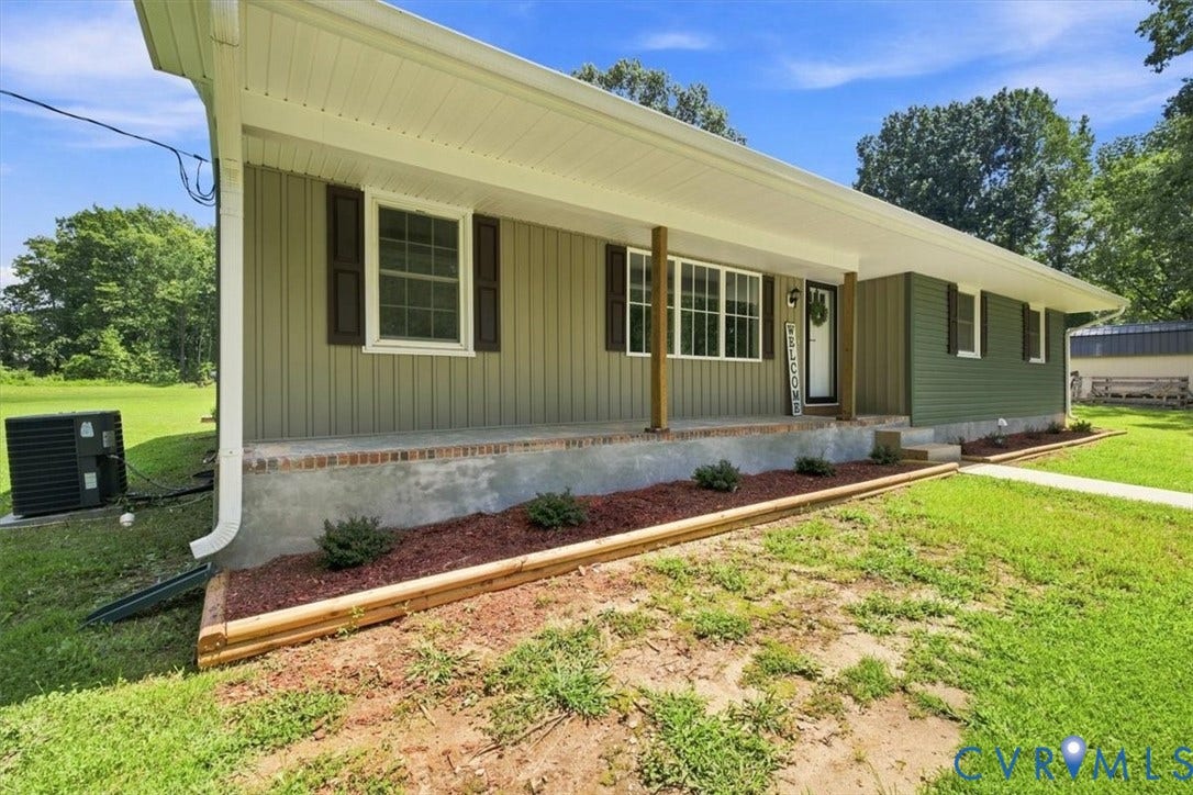 2338 Georges Road, Powhatan, VA 23139 Exterior featuring horizontal siding, dark shutters, covered front porch, and landscaped planting beds