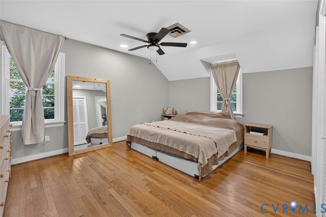 Hardwood flooring, sloped ceiling, ceiling fan, recessed lighting, and a double-hung window