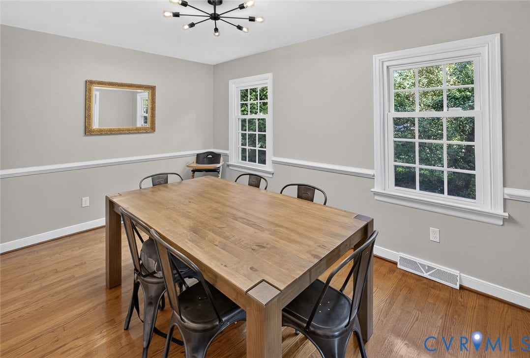 Hardwood flooring, crown molding, white trim, and a contemporary ceiling light fixture