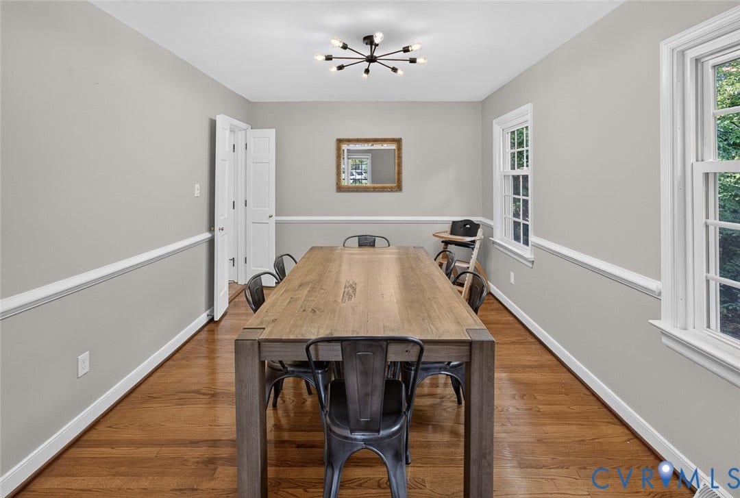 Hardwood flooring, crown molding, double windows, modern ceiling light fixture, and white trim