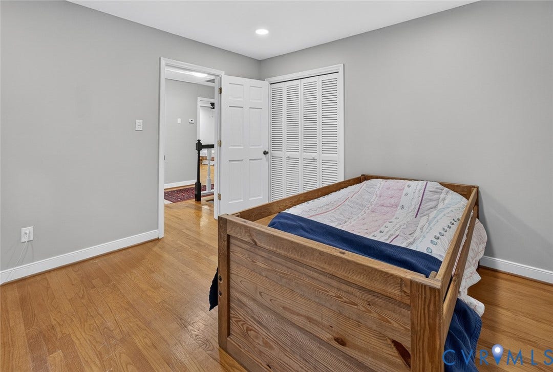Hardwood flooring, painted walls, white trim, recessed lighting, and bifold closet doors