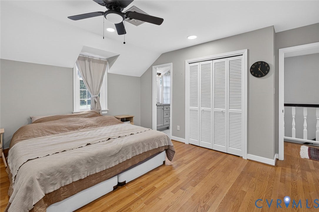 Hardwood flooring, recessed lighting, ceiling fan, bi-fold louvered closet doors, and sloped ceiling