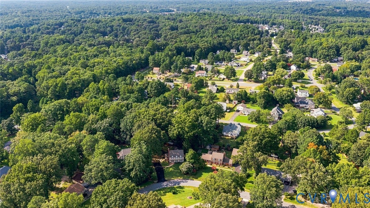 Expansive green landscape with residential properties and abundant mature trees