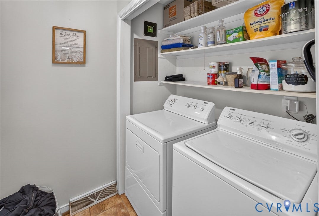 Laundry area featuring a side-by-side washer and dryer, built-in shelving, and tiled flooring