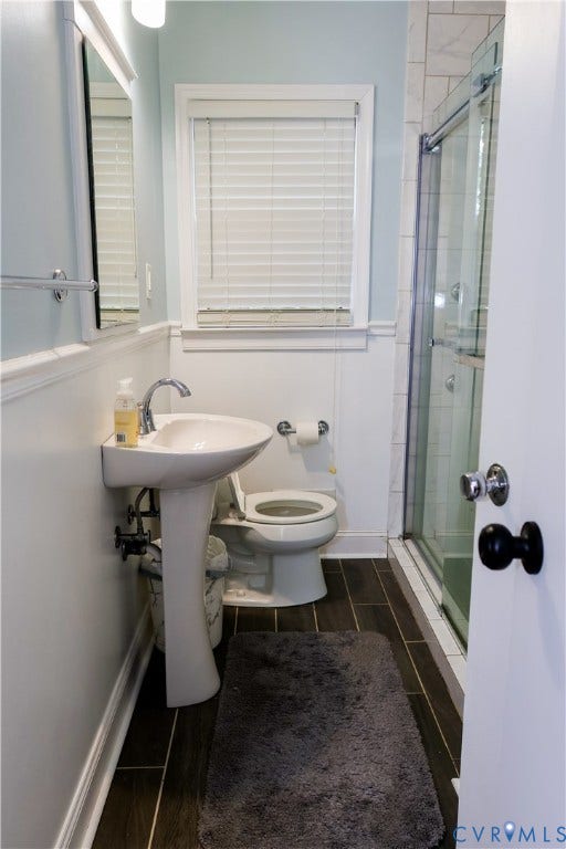 4941 Hopkins Road, Chesterfield, VA 23234 Pedestal sink with chrome faucet, glass-enclosed shower, and tile floors.