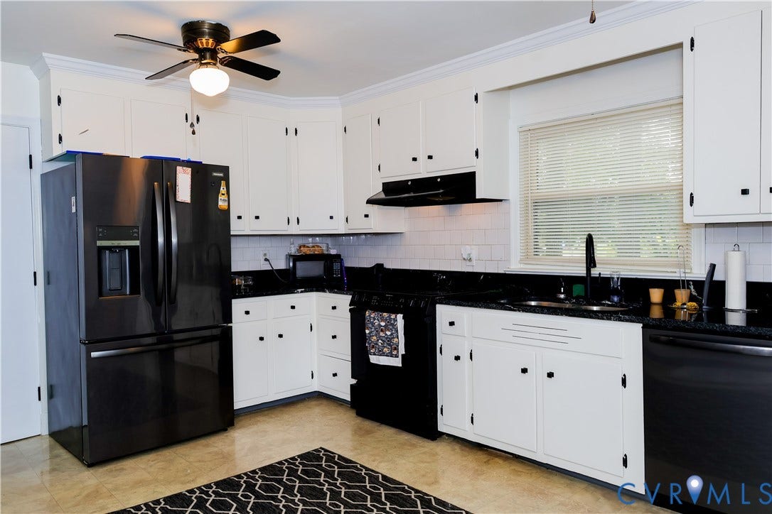 4941 Hopkins Road, Chesterfield, VA 23234 White cabinetry with black hardware, black countertops, and a white subway tile backsplash