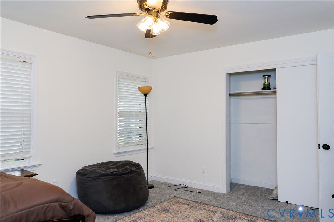 4941 Hopkins Road, Chesterfield, VA 23234 Downstairs Bedroom 1, a ceiling fan with integrated lighting, closet with sliding doors.