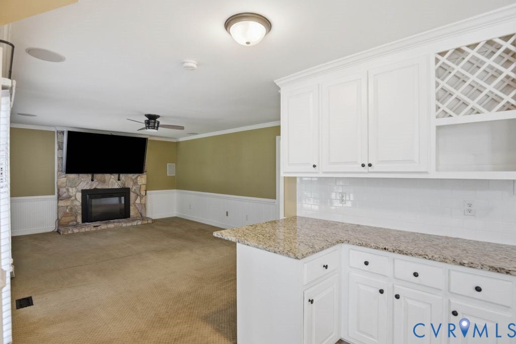 8806 Thornton Heath Drive, Chesterfield, VA 23832 White cabinetry with a lattice wine rack, solid surface countertop, and subway tile backsplash