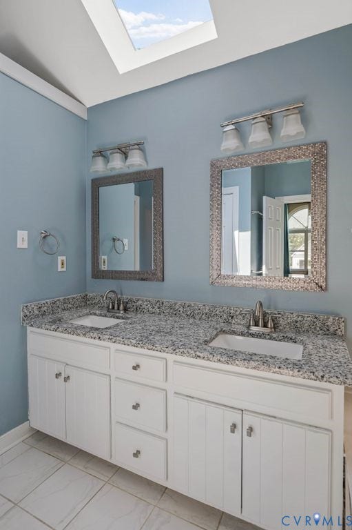 8806 Thornton Heath Drive, Chesterfield, VA 23832 Dual vanity with integrated sinks, speckled countertop, white cabinetry, and a skylight