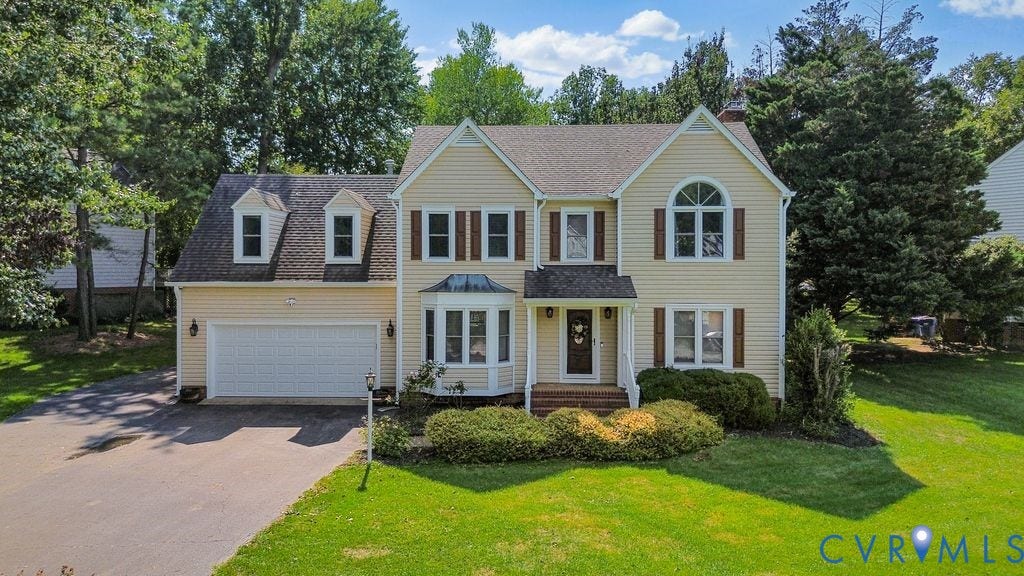 8806 Thornton Heath Drive, Chesterfield, VA 23832 Yellow siding exterior with white trim, a gabled roof, and dormer windows