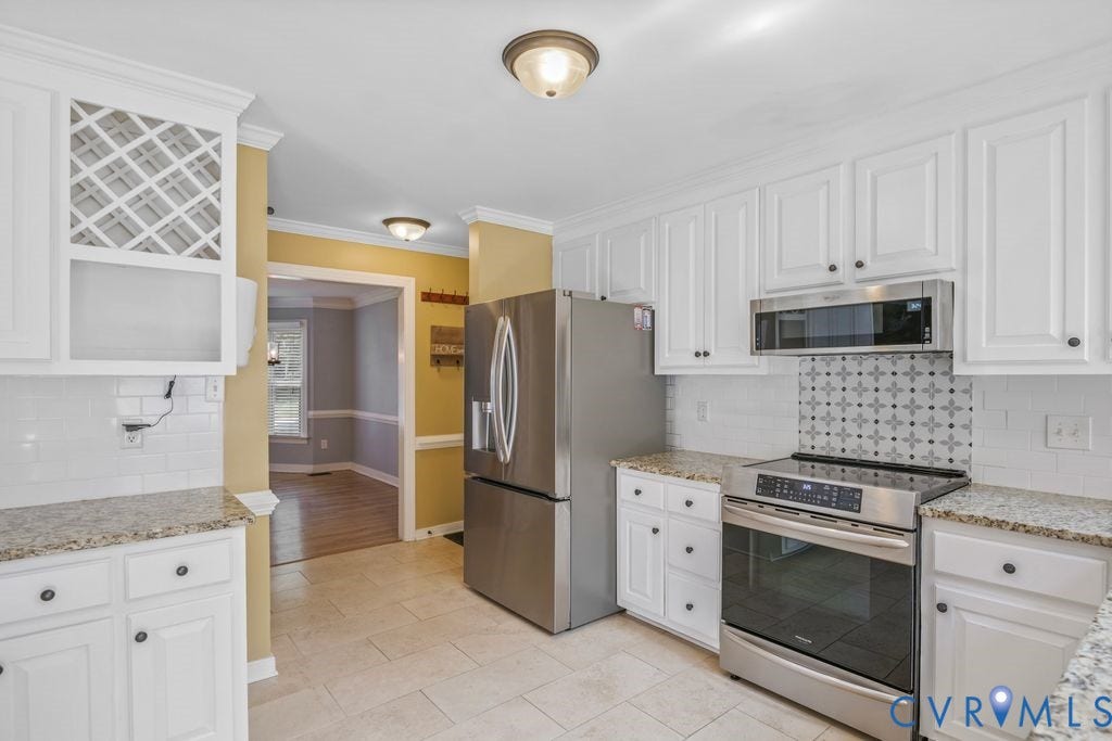 8806 Thornton Heath Drive, Chesterfield, VA 23832 White cabinetry, granite countertops, tile flooring, built-in stainless steel microwave, and stainless steel range