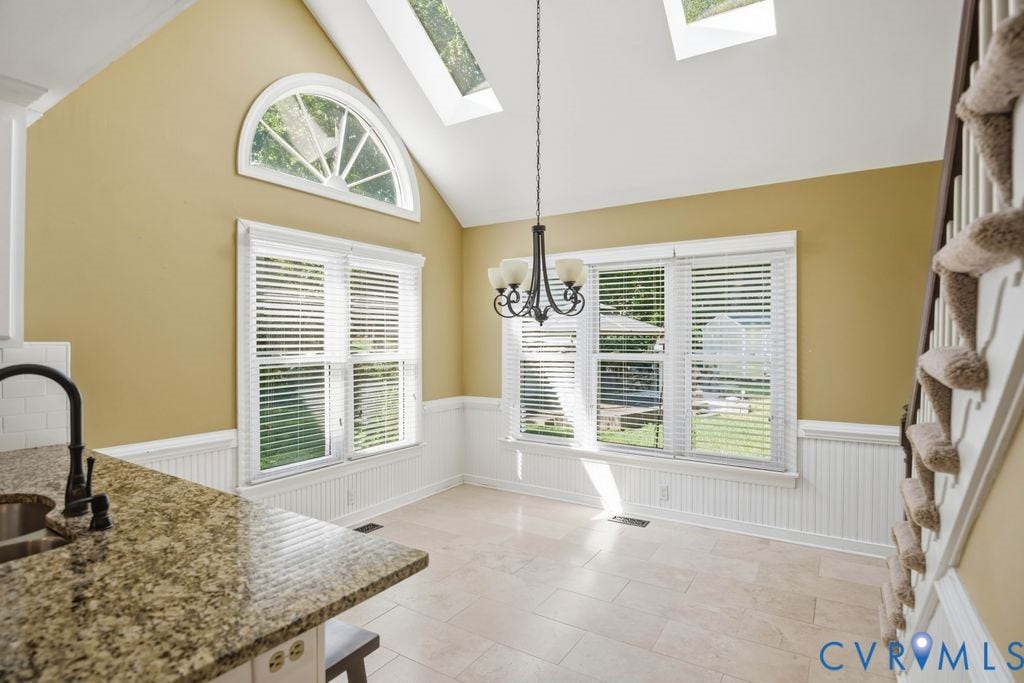 8806 Thornton Heath Drive, Chesterfield, VA 23832 Vaulted ceiling with skylights, arched transom window, beadboard wainscoting, and a granite-finish countertop