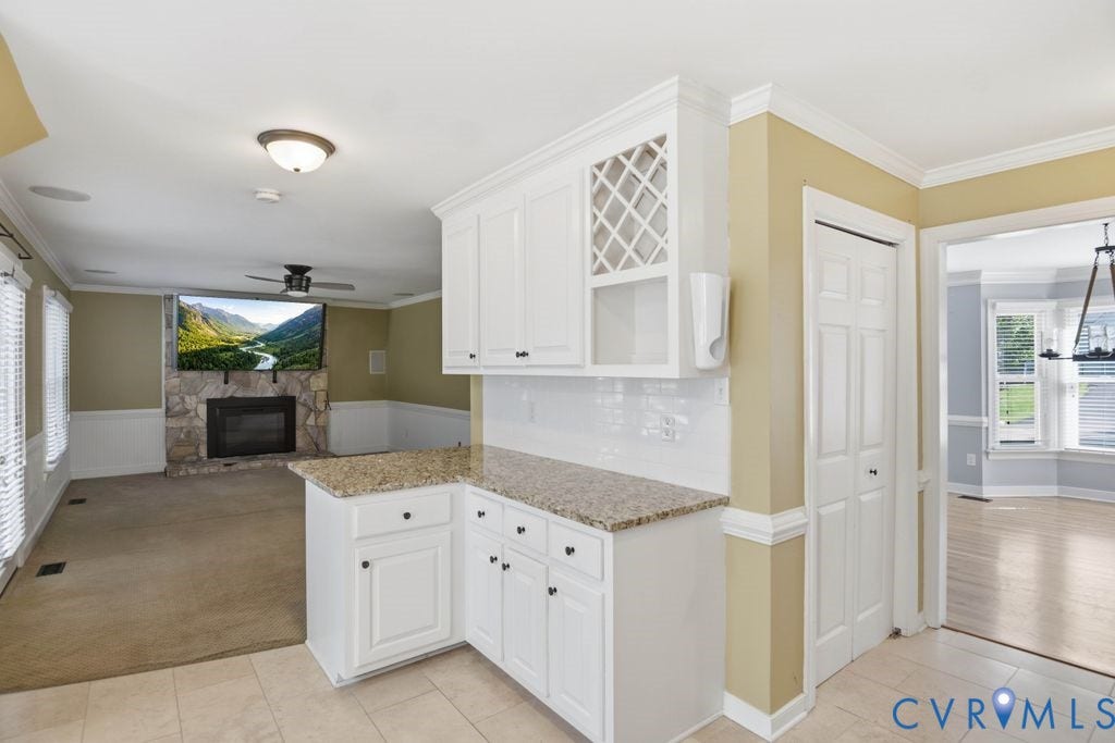 8806 Thornton Heath Drive, Chesterfield, VA 23832 Built-in white cabinetry, light-toned countertop, and a stone-clad fireplace