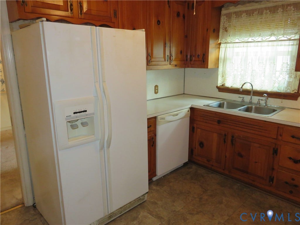 3107 Neale Street, Eastern Henrico, Richmond, VA 23223 Kitchen featuring wood cabinetry, a double basin stainless steel sink, white dishwasher, and a white side-by-side refrigerator