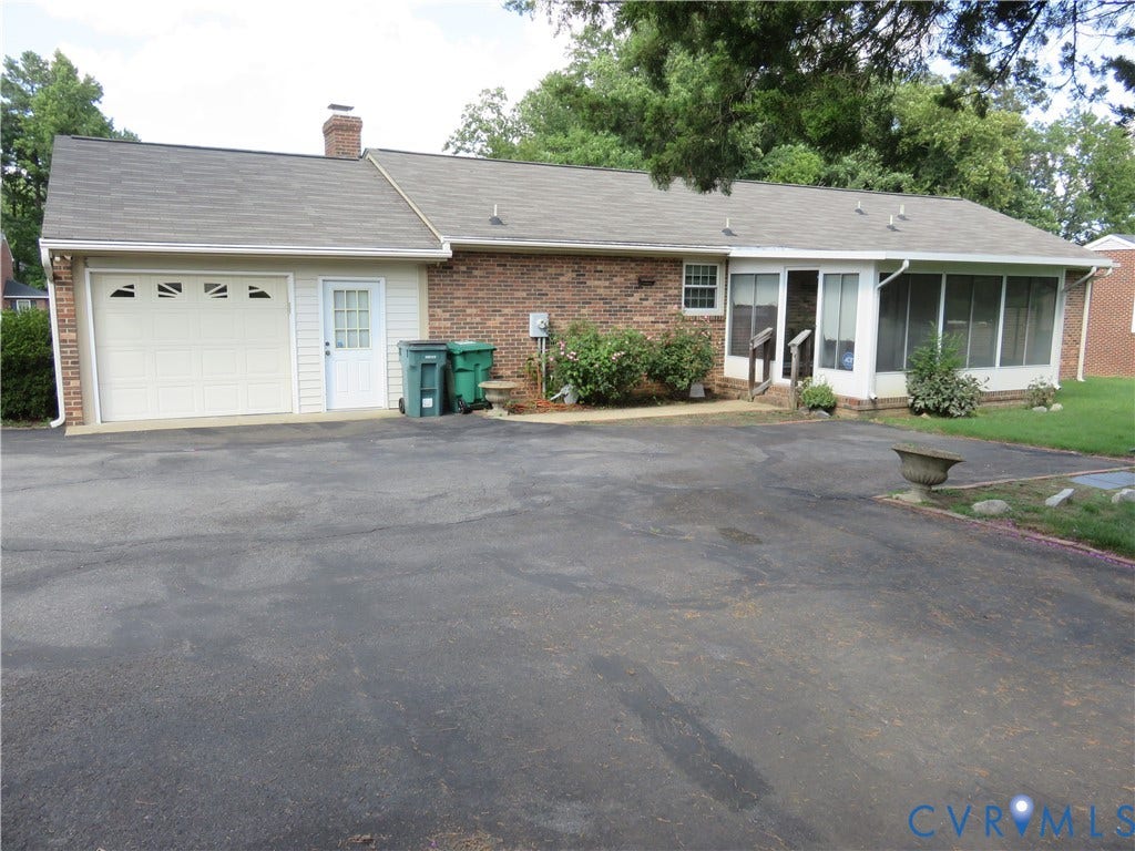 3107 Neale Street, Eastern Henrico, Richmond, VA 23223 Brick exterior with a single-car garage and an adjacent entry door