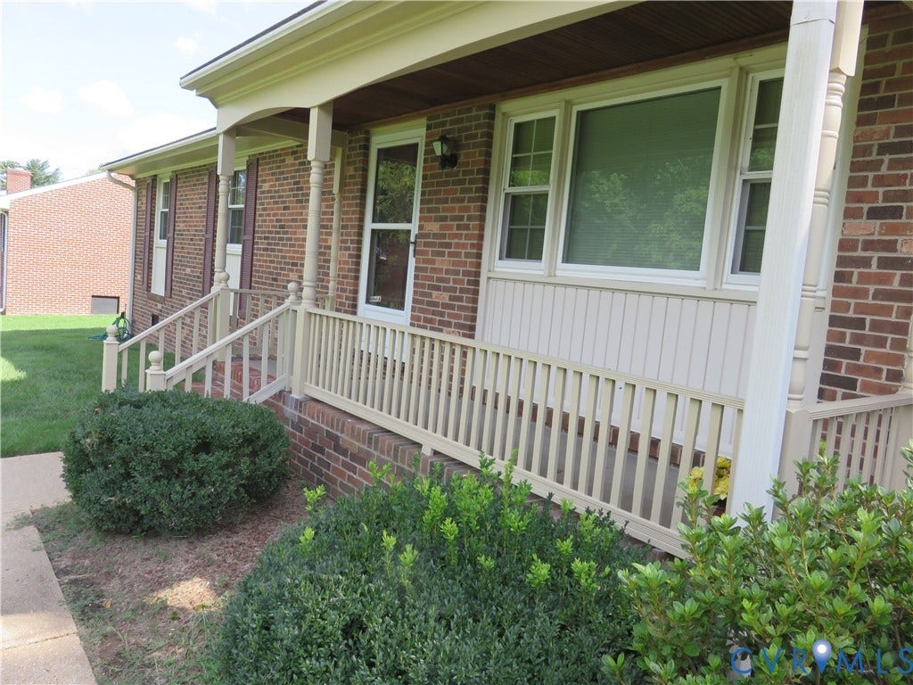 3107 Neale Street, Eastern Henrico, Richmond, VA 23223 Brick exterior with light-colored trim and a covered front porch featuring railings