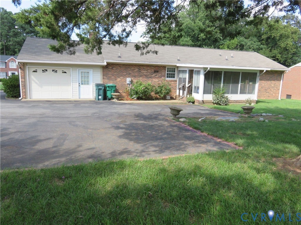 3107 Neale Street, Eastern Henrico, Richmond, VA 23223 Brick exterior, attached garage, screened-in porch, paved driveway, and established landscaping