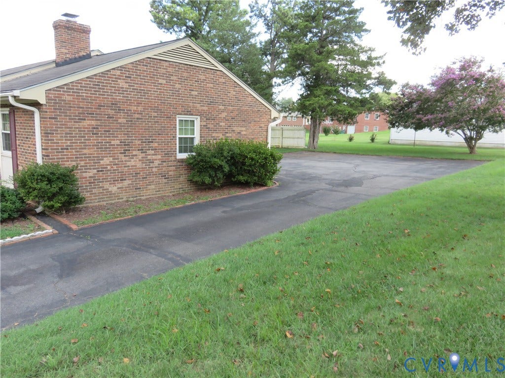 3107 Neale Street, Eastern Henrico, Richmond, VA 23223 Brick exterior with white trim, a gabled roof, and a prominent chimney
