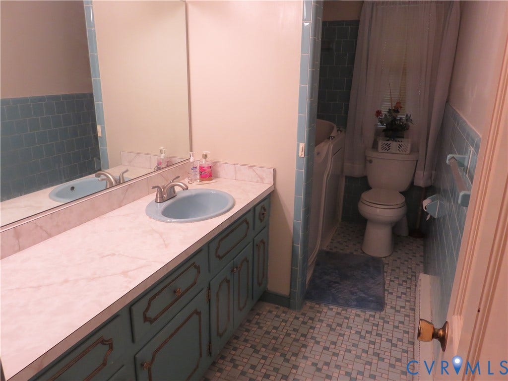 3107 Neale Street, Eastern Henrico, Richmond, VA 23223 Vanity with a single basin sink and a stone-look countertop