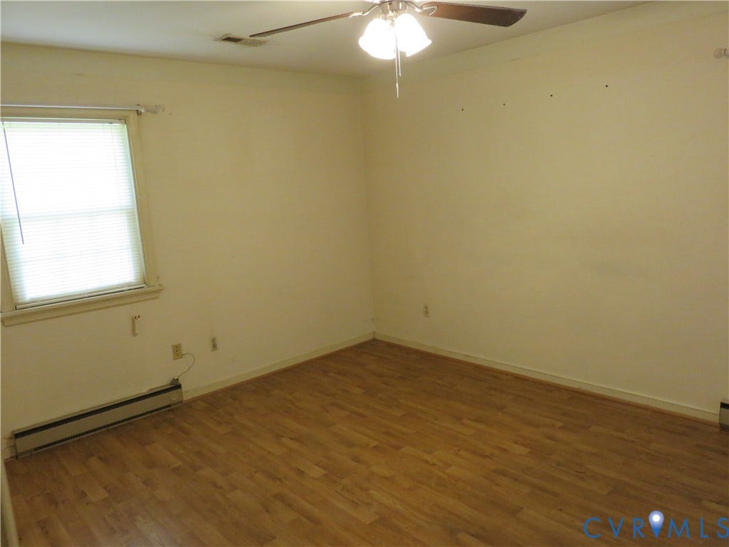 3107 Neale Street, Eastern Henrico, Richmond, VA 23223 Wood-finish flooring with a ceiling-mounted fan light fixture and a window with blinds