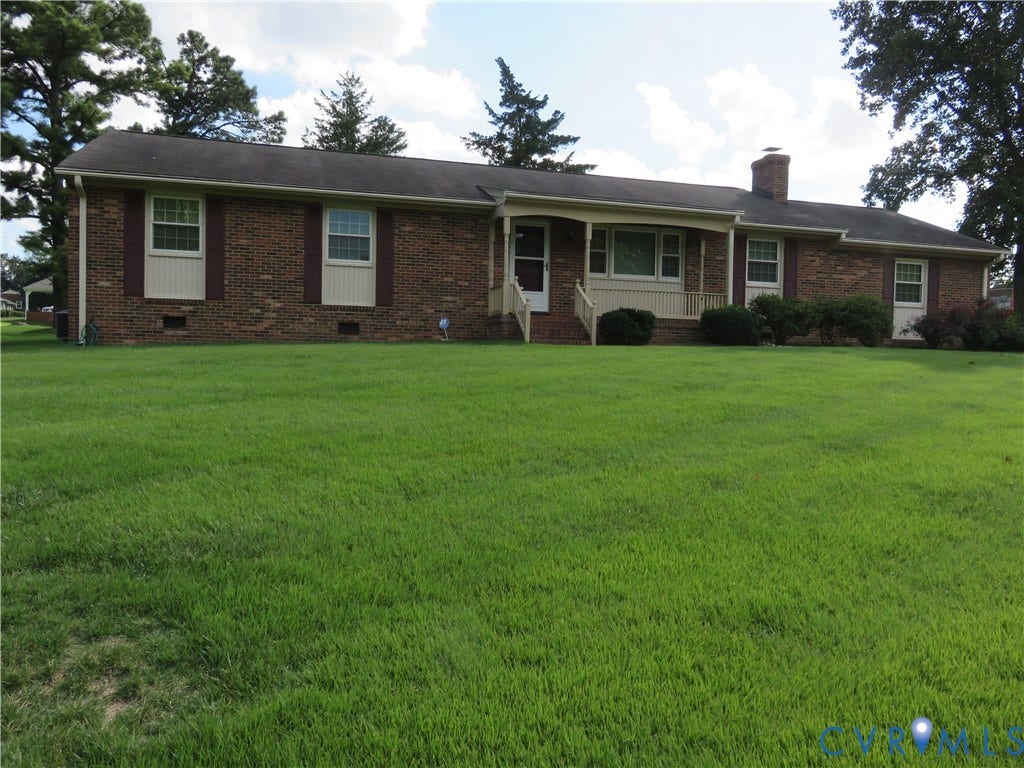 3107 Neale Street, Eastern Henrico, Richmond, VA 23223 Brick exterior with white trim, front porch, and expansive lawn