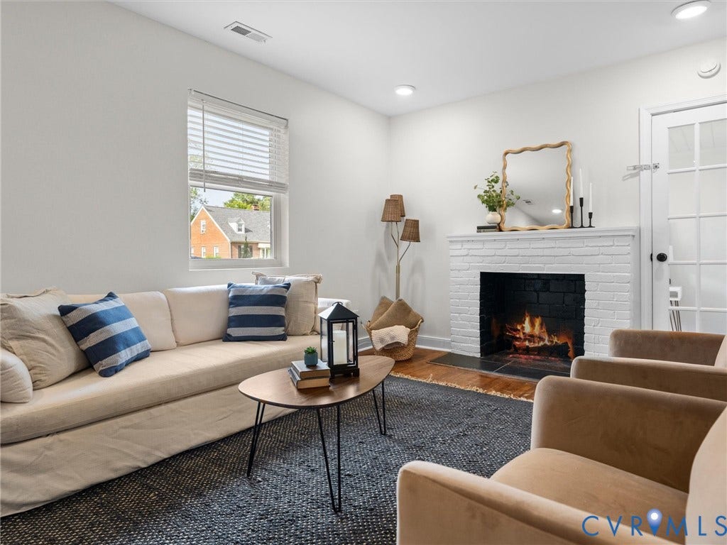 709 Ratcliffe Avenue, Richmond, VA 23222 Living area featuring a painted brick fireplace, a white mantel, and wood-finish flooring