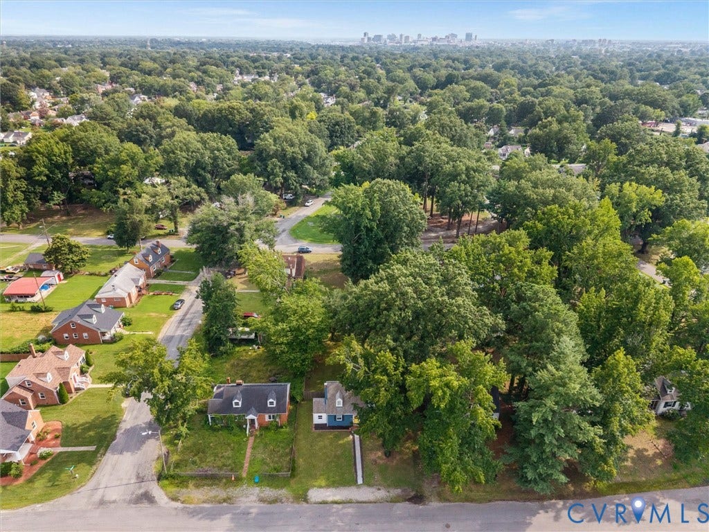 709 Ratcliffe Avenue, Richmond, VA 23222 Aerial perspective showcasing a residential neighborhood with abundant mature trees and distant city skyline