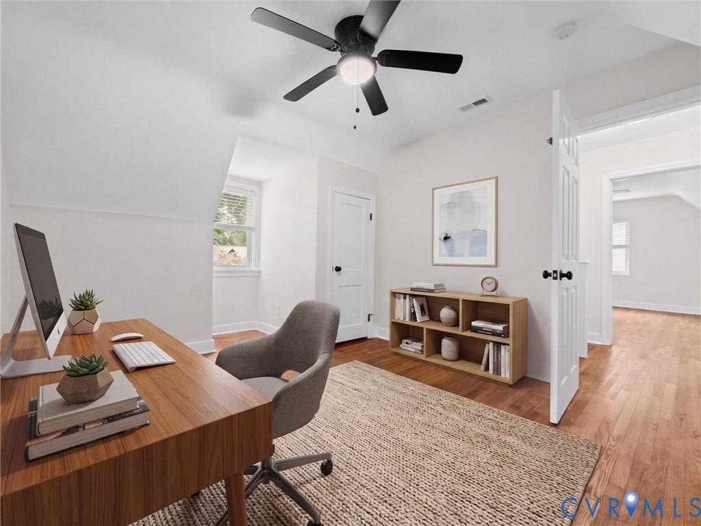 709 Ratcliffe Avenue, Richmond, VA 23222 Hardwood flooring with a natural finish, white painted walls, a black ceiling fan, white trim, and a white interior door with black hardware
*Virtually Staged