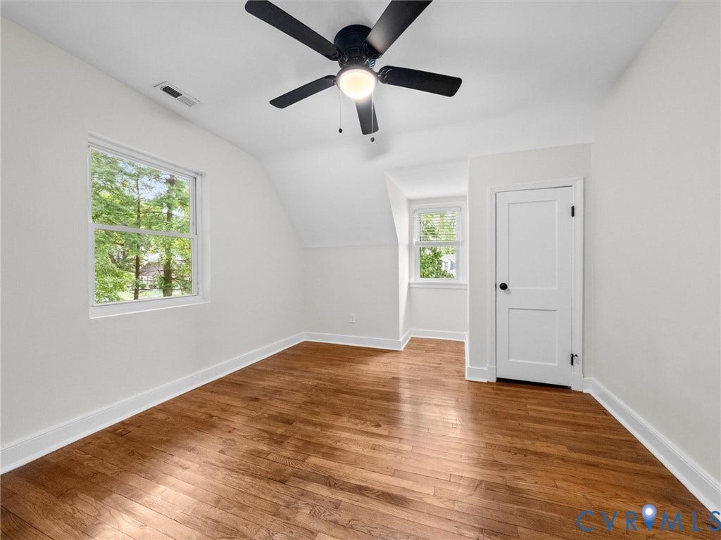 709 Ratcliffe Avenue, Richmond, VA 23222 Hardwood flooring, white walls, two windows, ceiling fan with integrated lighting, and a paneled door