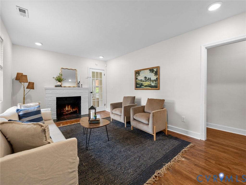 709 Ratcliffe Avenue, Richmond, VA 23222 White brick fireplace, recessed lighting, wood-finish flooring, white walls, and a glass-paneled door