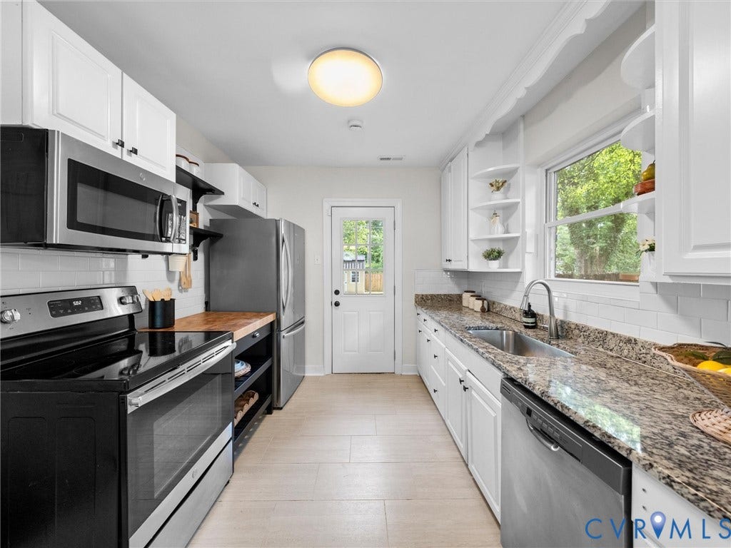 709 Ratcliffe Avenue, Richmond, VA 23222 Galley kitchen featuring stainless steel appliances, white cabinetry, wood-finish flooring, and stone countertops