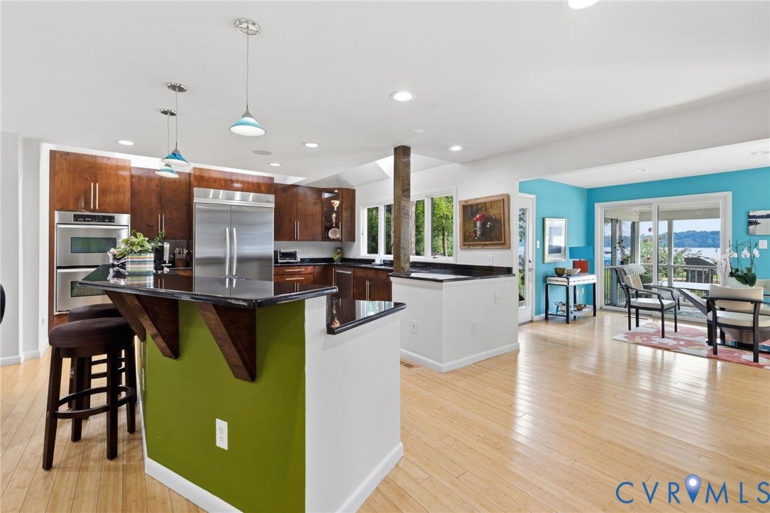 3416 Walkers Ferry Road, Walkers Ferry, Midlothian, VA 23112 Wood-finish flooring throughout, kitchen featuring stainless steel appliances, dark wood-finish cabinetry, and dark countertops