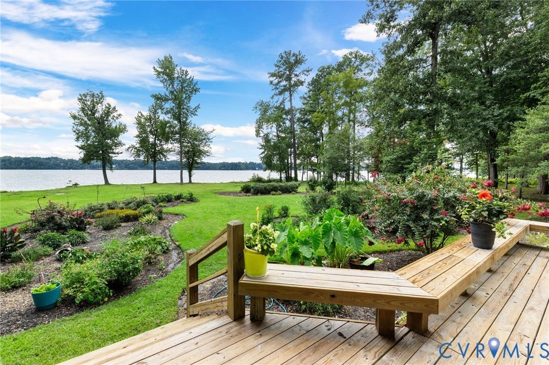 3416 Walkers Ferry Road, Walkers Ferry, Midlothian, VA 23112 Expansive waterfront yard with manicured lawn, established landscaping, and a wood-plank deck featuring built-in bench seating