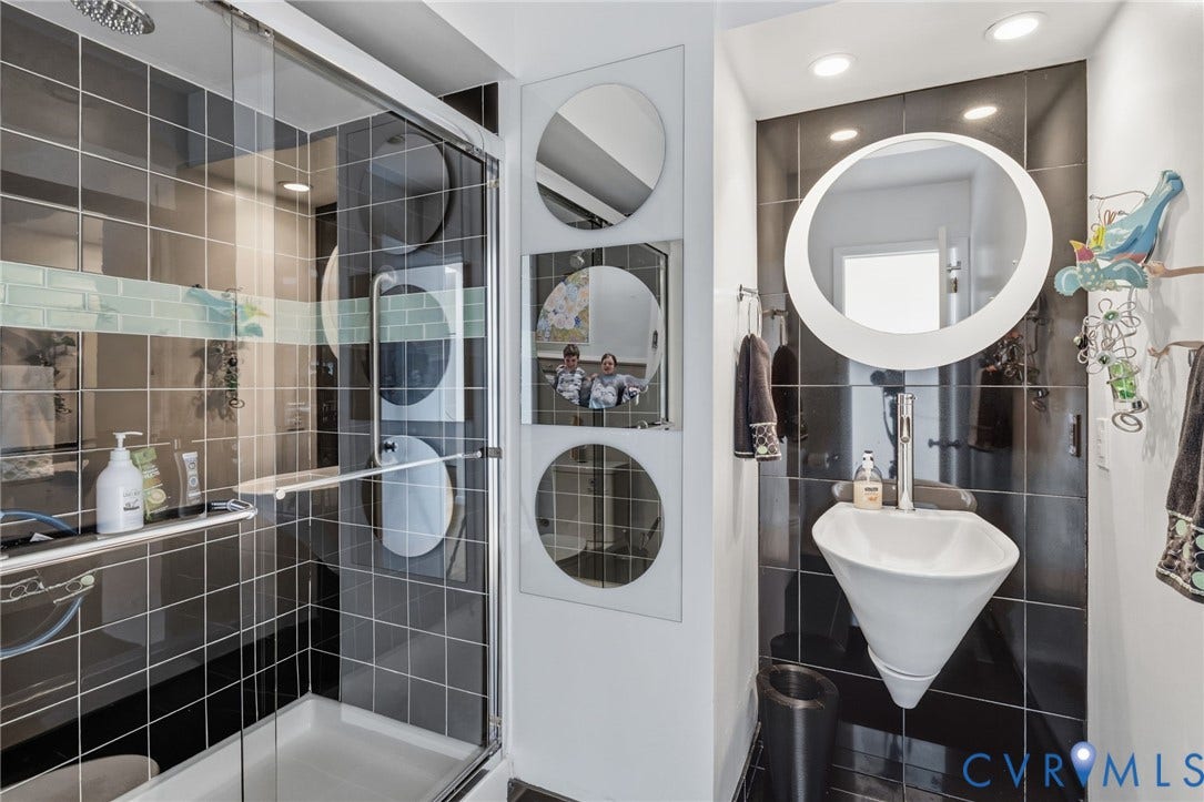 3416 Walkers Ferry Road, Walkers Ferry, Midlothian, VA 23112 Glass-enclosed shower with black tile surround and decorative glass accent
