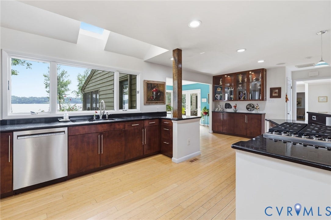 3416 Walkers Ferry Road, Walkers Ferry, Midlothian, VA 23112 Wood-finish flooring with dark wood cabinetry, stainless steel dishwasher, black countertops, and a built-in gas range