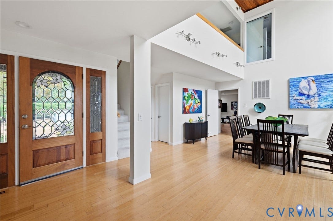 3416 Walkers Ferry Road, Walkers Ferry, Midlothian, VA 23112 Wood-finish flooring throughout, two-story ceiling, natural wood front door with leaded glass, and an interior balcony