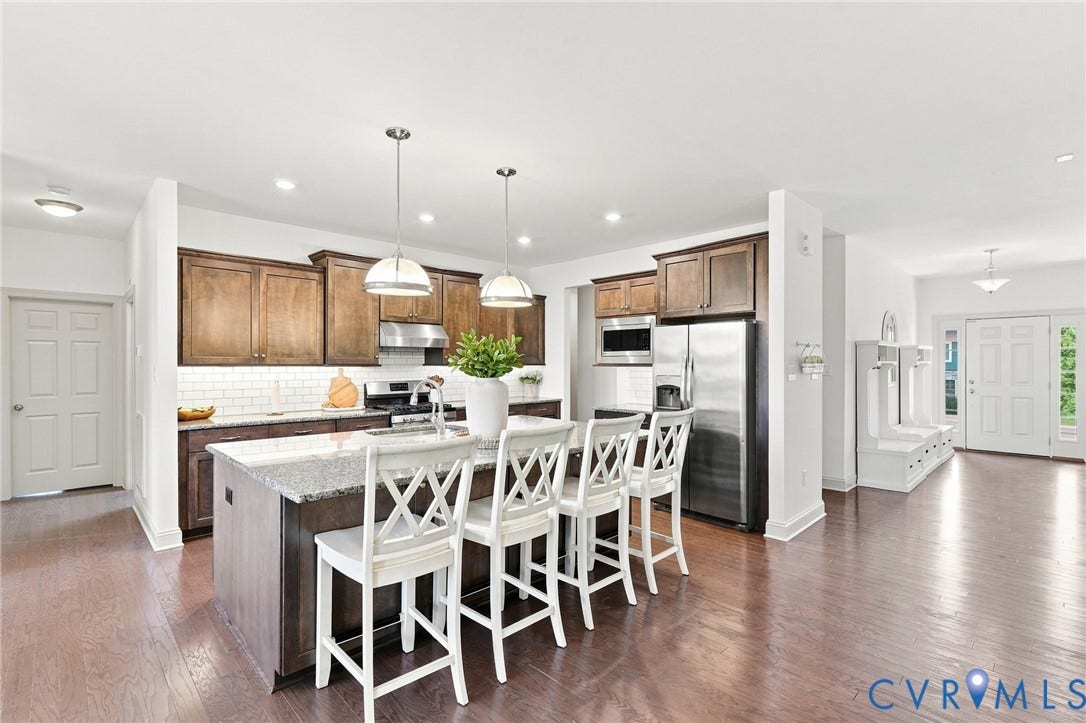6907 Carden Park Drive, Carden Park, Moseley, VA 23120 Kitchen island with granite countertop, stainless steel appliances, hardwood flooring, and white subway tile backsplash
