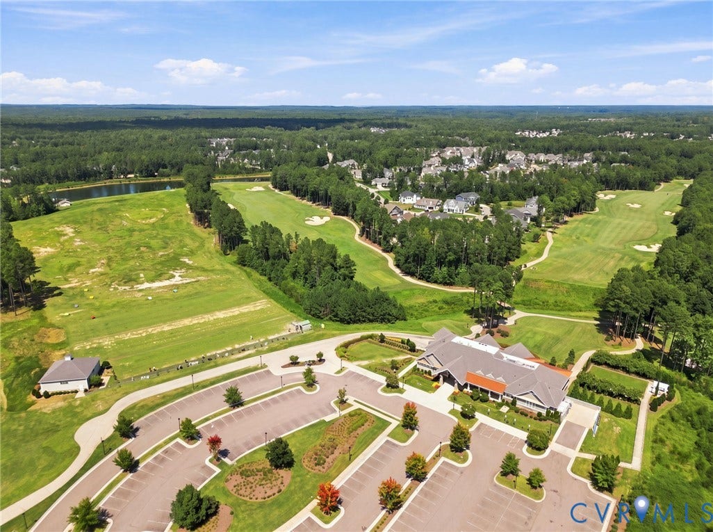 6907 Carden Park Drive, Carden Park, Moseley, VA 23120 Expansive golf course setting featuring multiple greens, a driving range, a large clubhouse, and a dedicated parking area