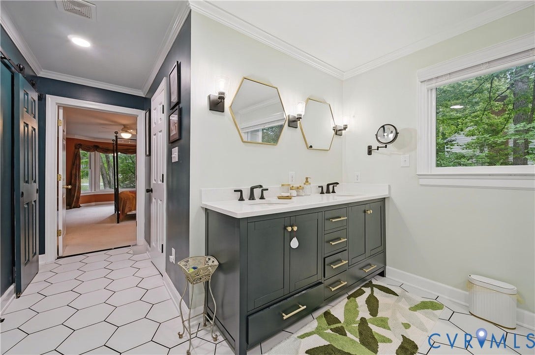 411 Hickory Drive, Manakin Sabot, VA 23103 Dual vanity with white countertop and integrated sinks, hexagon tile flooring, and a large window